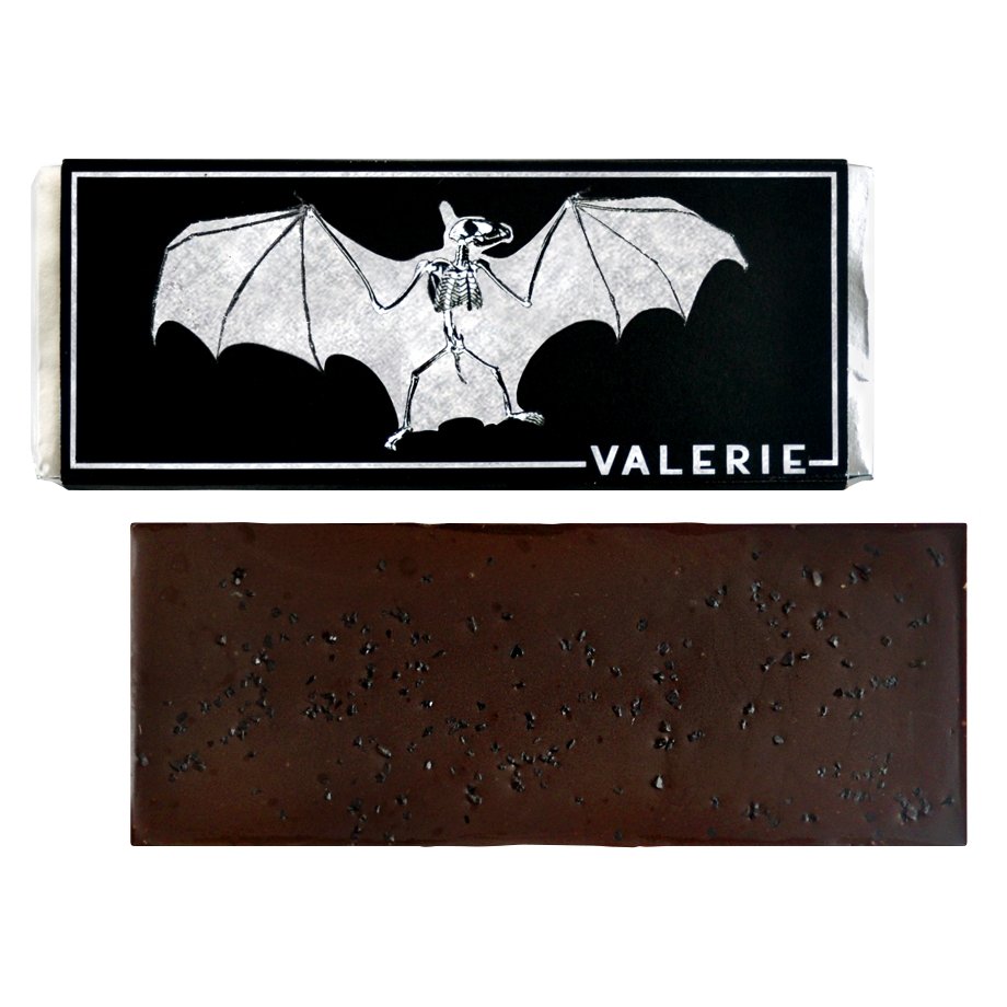 A 72% bittersweet chocolate bar with black lava salt, unwrapped and displayed with its bat-themed packaging.