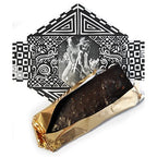 An unwrapped GOOD MIX BAR, revealing dark chocolate with embedded almonds, cocoa nibs, and seeds, next to its artistic, vintage-inspired packaging.