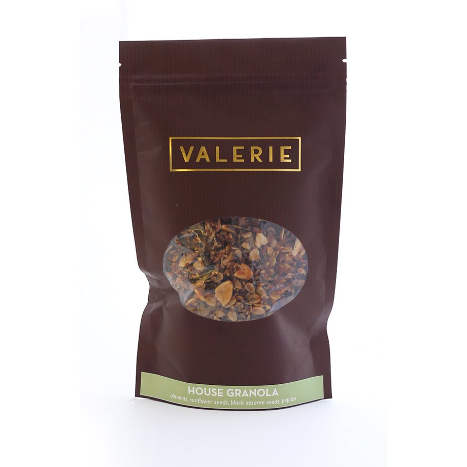 A brown resealable bag of Valerie Confections House Granola, labeled with ingredients and ready for gifting or enjoying at home.